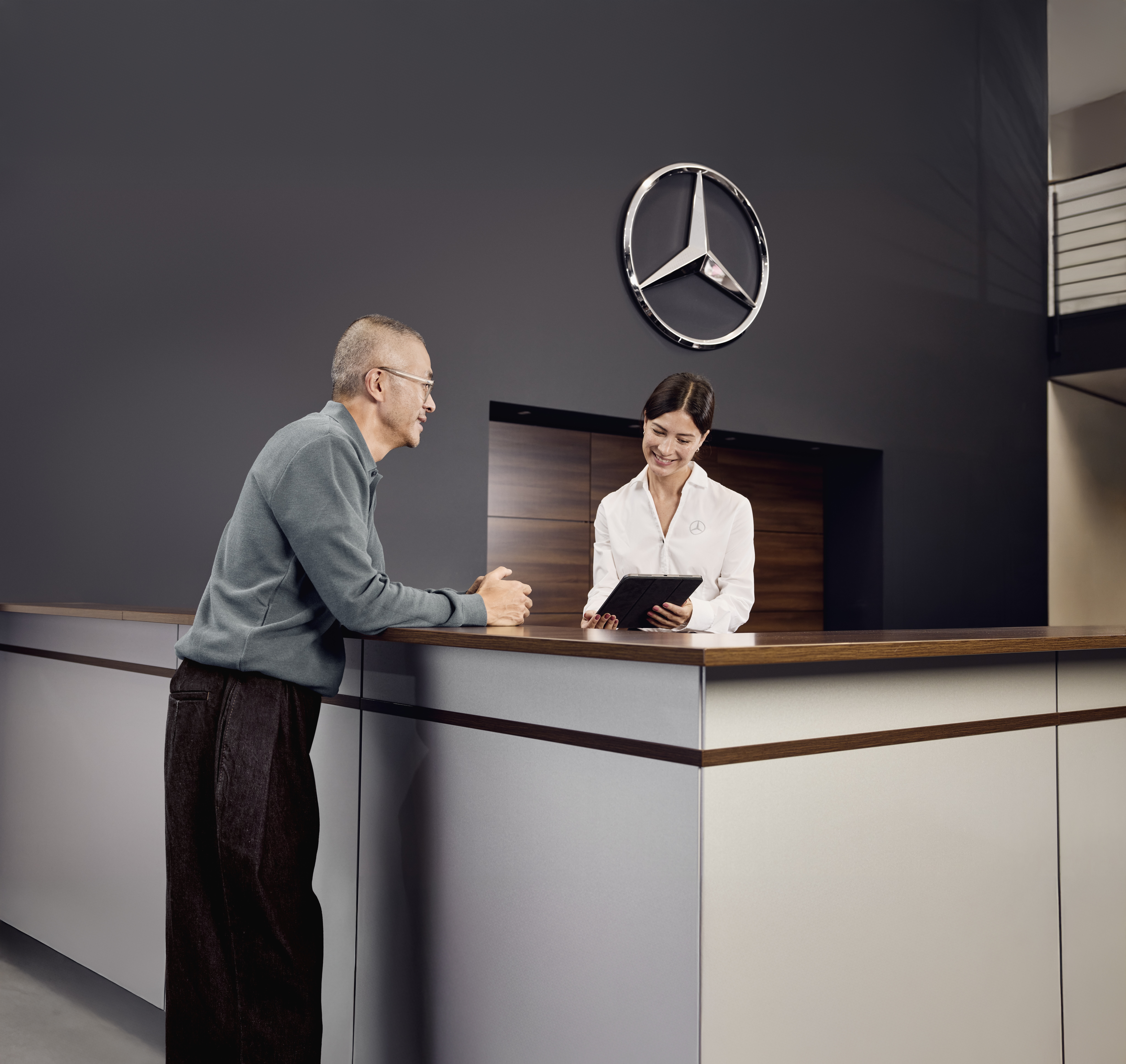Mercedes‑ Benz Orijinal Parça Danışmanlığı Mercedes-Benz bayisindeki servis kabulünde bir müşteri, aracın servisiyle ilgili ayrıntıları resepsiyondaki servis danışmanıyla görüşüyor.