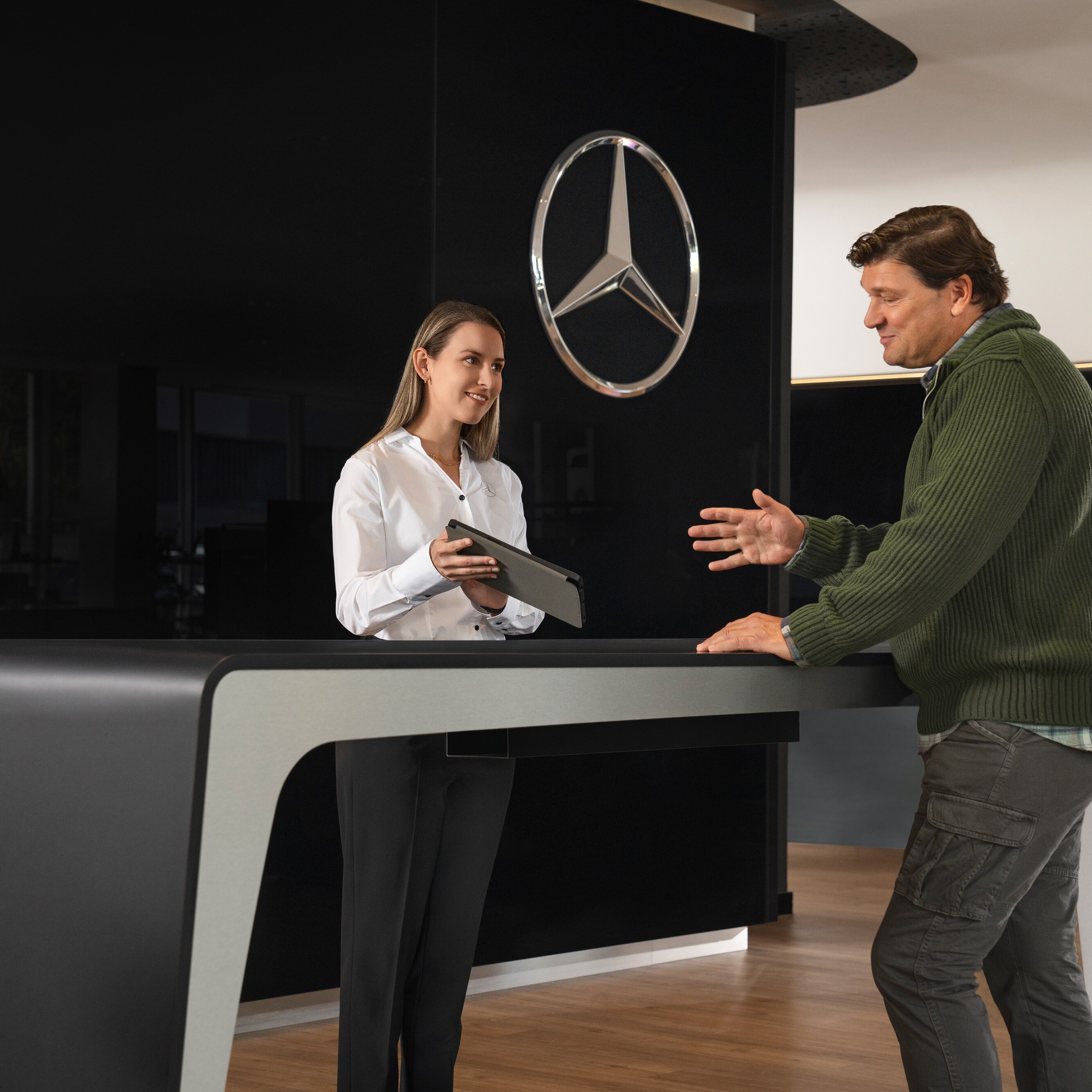 A Mercedes-Benz adviser provides a customers with personalised information.